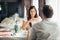 Smiling woman on a date in a restaurant,having a conversation over a meal in hotel.Positive emotions,love,affection