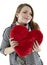 Smiling woman embraces a heart pillow