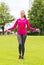 Smiling woman exercising with jump-rope outdoors