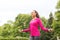 Smiling woman exercising with jump-rope outdoors