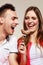 Smiling woman feeding happy man with cake.