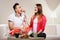 Smiling woman feeding happy man with cake.