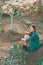 Smiling woman gardening backyard housework hobby.