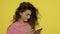 Smiling woman gesturing on mobile phone. Young woman looking photo on smartphone