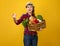 Smiling woman grower with box of fresh vegetables beckoning