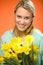 Smiling woman hold yellow narcissus spring flowers