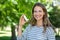 Smiling woman holding asthma inhaler