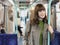 Smiling Woman Holding Bar In Commuter Train