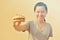 Smiling woman holding burger in hand, american unhealthy food