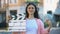 Smiling woman holding clapperboard and bunch of dollars, high-paid occupation