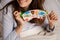 Smiling woman holding a cute sleep mask with the owl print