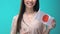 Smiling woman holding Japanese flag on blue background, foreign language study