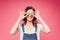 Smiling woman holding kiwi fruit over eyes isolated