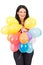 Smiling woman holding plenty balloons