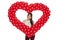 Smiling woman holding red balloon heart