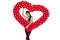 Smiling woman holding red balloon heart