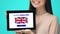 Smiling woman holding tablet with learn English language test, educational app