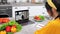 Smiling woman in home kitchen study remote cooking lesson listen chef teacher