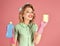Smiling woman housewife dressed in retro style. Happy Housekeeper. Retro woman cleaner on pink background. Pinup woman