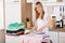 Smiling Woman Ironing Clothes With Electric Iron