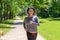 Smiling woman jogging towards the camera