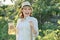 Smiling woman with jug of refreshing natural homemade drink in the summer garden