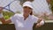 Smiling woman leaning on fence with tennis racket