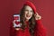 smiling woman with long wavy hair, smartphone and Valentine app
