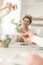 Smiling woman looking at friend serving salad to man