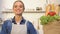 Smiling woman looking at paper bag with fresh bread, fruits and vegetables