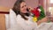 Smiling woman lover calling her man and thank for beautiful flowers bouquet