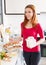 Smiling woman making omelet with flour