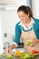 Smiling woman making salad vegetables kitchen preparing