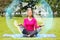 Smiling woman meditating on mat outdoors