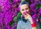 Smiling woman near colorful magenta flowers bed having fun time