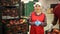 Smiling woman offers to inspect automatic fruit sorting line at factory warehouse