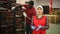 Smiling woman offers to inspect automatic fruit sorting line at factory warehouse