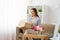 Smiling woman opening parcel box at home