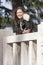 Smiling woman outdoor, overlooking on marble balcony