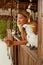 Smiling woman with parrot at tropical spa resort in summer