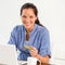 Smiling woman paying bills online banking home