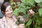 A smiling woman picking runner beans