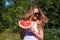 Smiling woman with a piece of watermelon