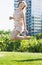 Smiling woman is playfully jumping in the park