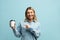 Smiling Woman Pointing at Coffee Isolated. Blonde Female Holding Coffee to Go