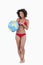 Smiling woman pointing a globe beach ball