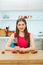 Smiling woman portrait in kitchen with wine glass.