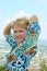 Smiling woman posing in front of camera on the city roofs background