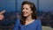 Smiling woman presenter interacting with talk show audience in studio close up.