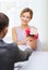 Smiling woman recieving bouquet of flowers